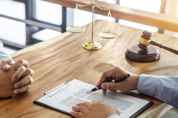 Law, lawyer attorney and justice concept, Consultation between a male lawyer and client, giving advice and prosecutions about the regarding real estate, report of the important case in the workplace.